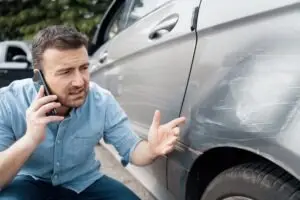 A man wonders, “How can I estimate the damage to my car after an accident?”