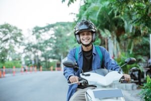 A man rides a motorcycle with a helmet on. Contact a Gardena motorcycle accident lawyer now.