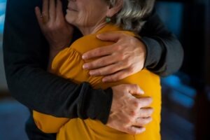 man-and-elderly-woman-hug-after-truck-accident-case-victory