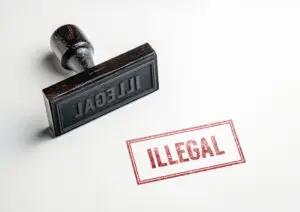 A rubber stamp says illegal in red ink on a white background. A child pornography lawyer can explain how lolicon is considered illegal on a federal level but not in all states.