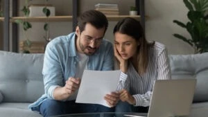 A couple reviewing their final legal bill that shows how much a criminal defense lawyer costs them.