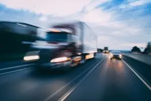 An 18-wheeler speeding on a highway