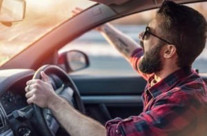 An angry driver screams behind the wheel