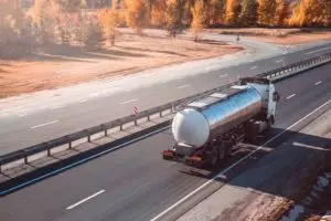 A fuel truck drives on a highway