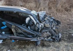 A wrecked car after a truck accident