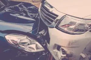 A close-up view of a head-on collision between two cars.