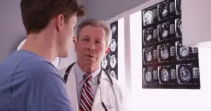A doctor talking with a patient about his brain scan results.