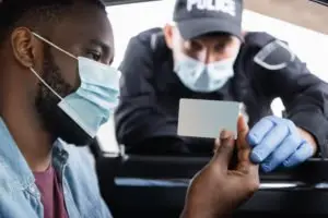A driver showing his license to a police officer.