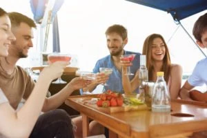 Friends drinking on a boat.