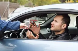 A man argues with a police officer over a breath test