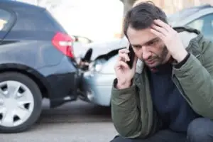 A man makes a call after a rear-end accident
