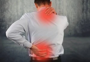 A man rubbing sore spots on his neck and back.