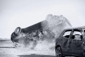 A car is overturned after a collision with another vehicle.