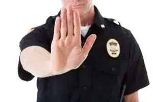 A police officer holding up his hand.