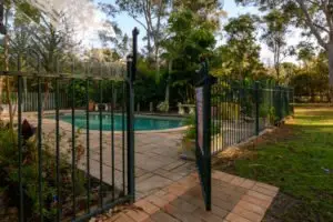 A swimming pool with an open gate.