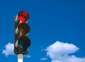 A traffic light against a blue sky.