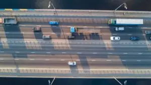 An aerial view of trucks and cars on a bridge