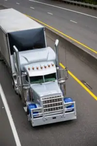 A big rig driving on a highway.