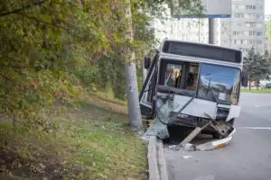 A damaged bus sitting on the roadside.