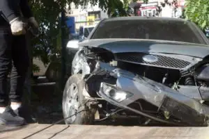 A gray car with front-end damage.