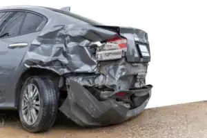 A gray car with rear-end damage.