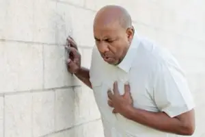 A man gripping his chest in pain