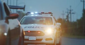 A police car pursuing a fleeing car.