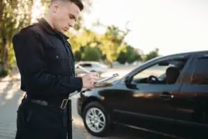 A police officer writing a traffic ticket.