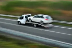 A tow truck speeding on a highway