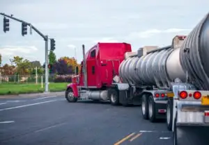 A truck making a wide turn at an intersection.