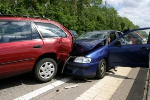 A collision between a red and blue car.