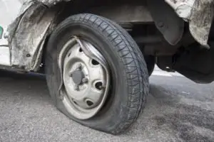A damaged tire on a truck.