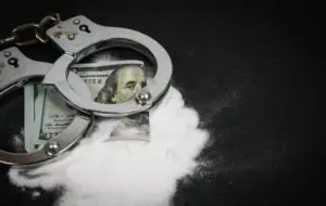 money with handcuffs and drugs