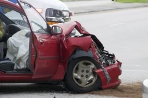 A red car with front-end damage.