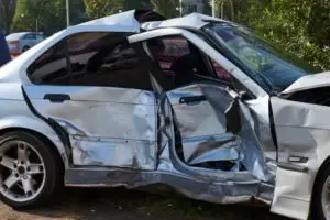 A silver car after a side-impact crash