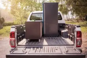 A truck with appliances in the bed.