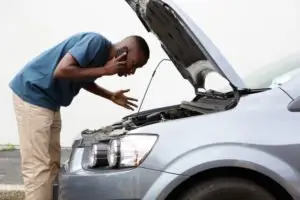 black man diagnosing car problem