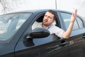 guy leaning out of car window angrily