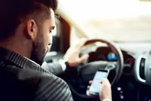 guy texting while driving