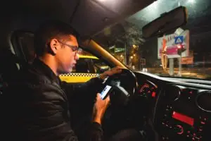 guy texting while driving at night