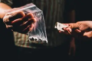 people exchanging drugs and cash