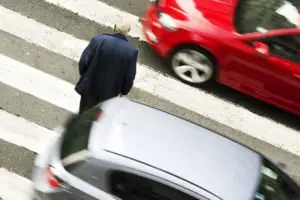 person crossing a dangerous crosswalk