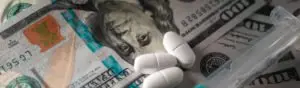 pills on hundred-dollar bills