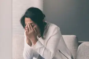 woman crying into her hands