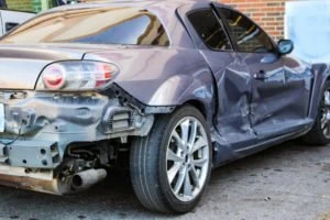 wrecked silver car after a side-impact crash