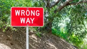 wrong-way sign on a mountain path