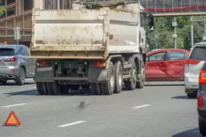 garbage truck and red car in accident