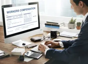 man filling out workers’ compensation form online