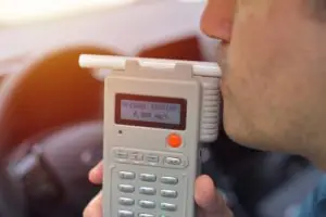man taking a breathalyzer test
