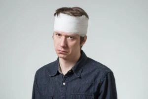 man with a head bandage